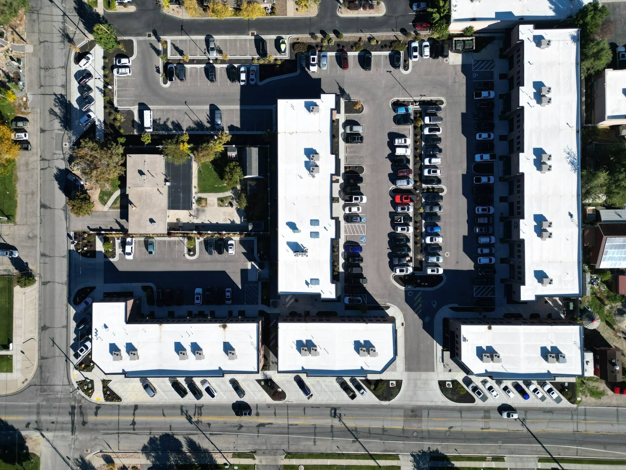 Overhead aerial of a multi-building commercial property with parking courts